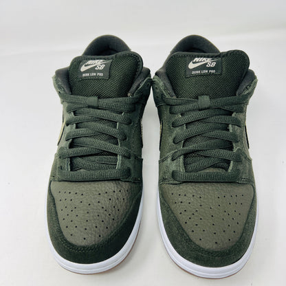 Authentic Nike SB Dunk Low Sequoia White Gum sneakers in green, featuring perforated toe boxes and white midsoles with white branding on the tongue, are showcased against a plain white background.