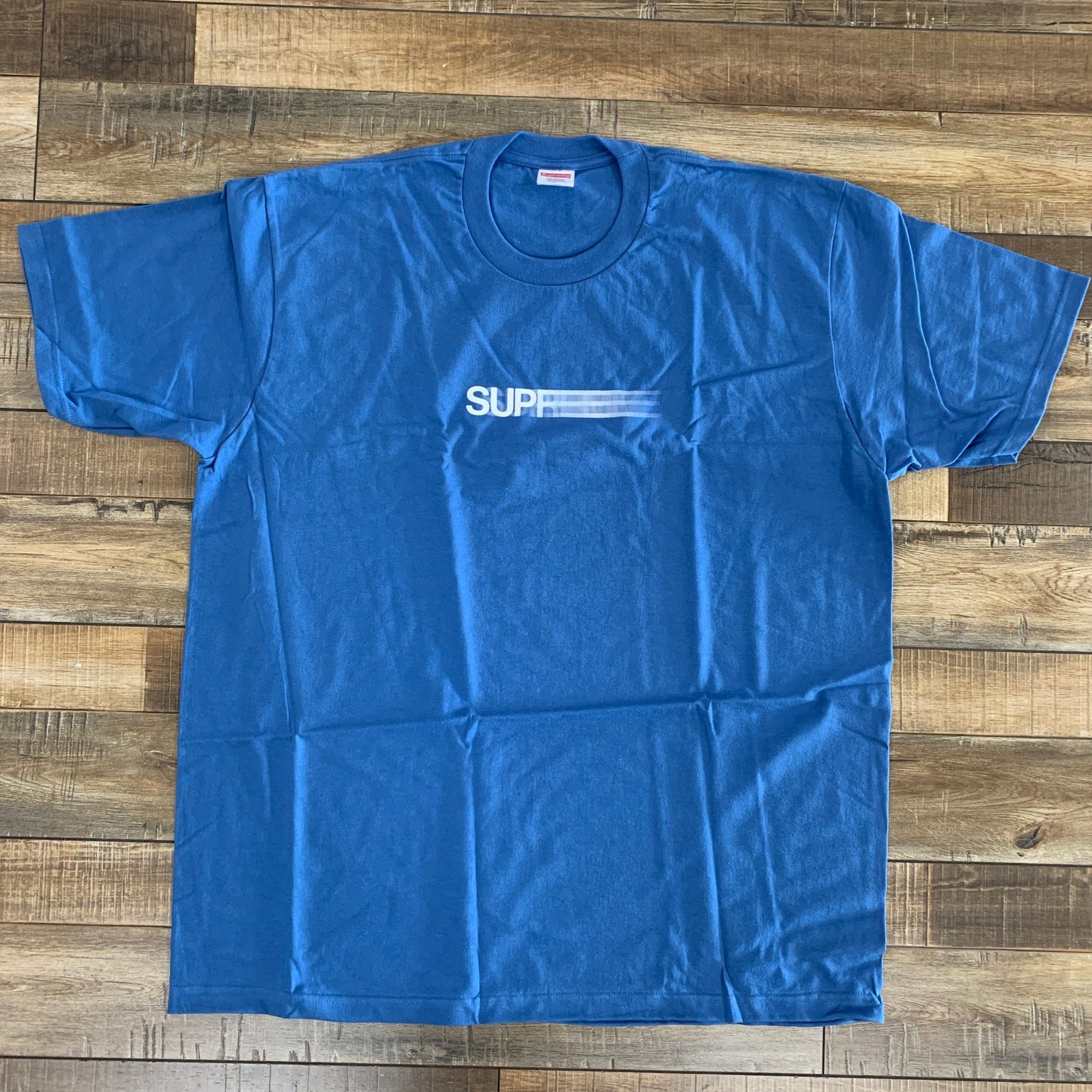 Supreme Motion Logo Tee SS23 in faded blue, brand new condition.