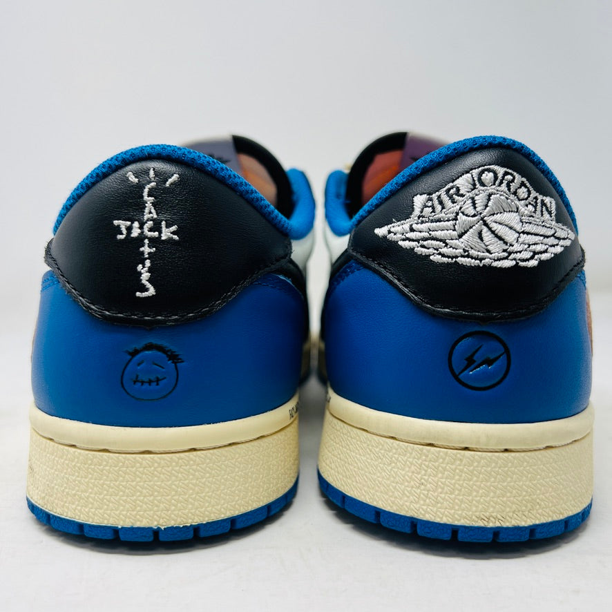 The Jordan 1 Retro Low OG SP Fragment x Travis Scott features a cream and black upper, blue heel and collar, and a cream sole with a signature swoosh design. Displayed against a plain backdrop without a box, it includes extra laces for versatility.