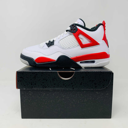 Jordan 4 Retro Red Cement (GS) sneaker with red and cement grey accents on a black box.