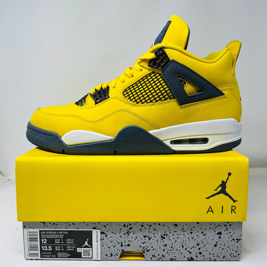 Jordan 4 Retro Lightning 2021 sneakers with yellow uppers and white soles, box shown.