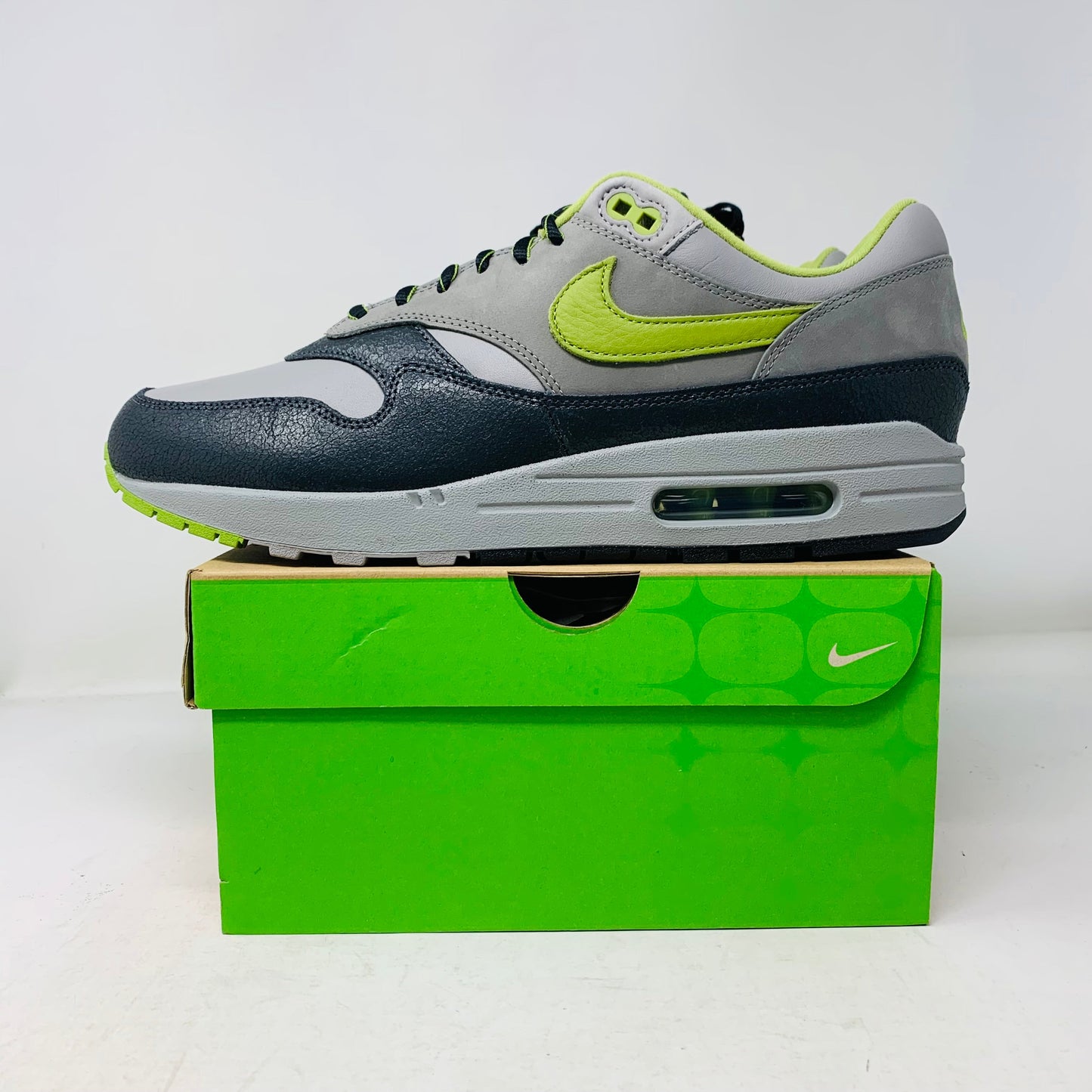 Nike Air Max 1 SP HUF Pear Green 2024 sneakers with hang tag and laces, displayed on a box.