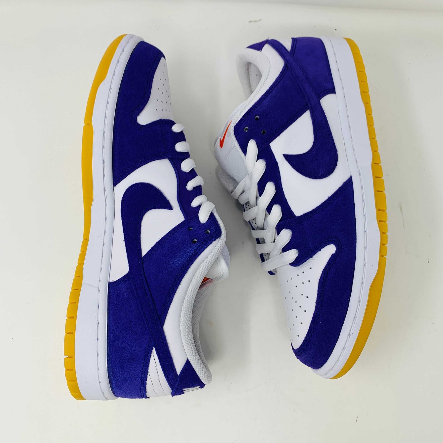 Nike SB Dunk Low Pro ISO Orange Label Court Purple sneakers with white and yellow accents.