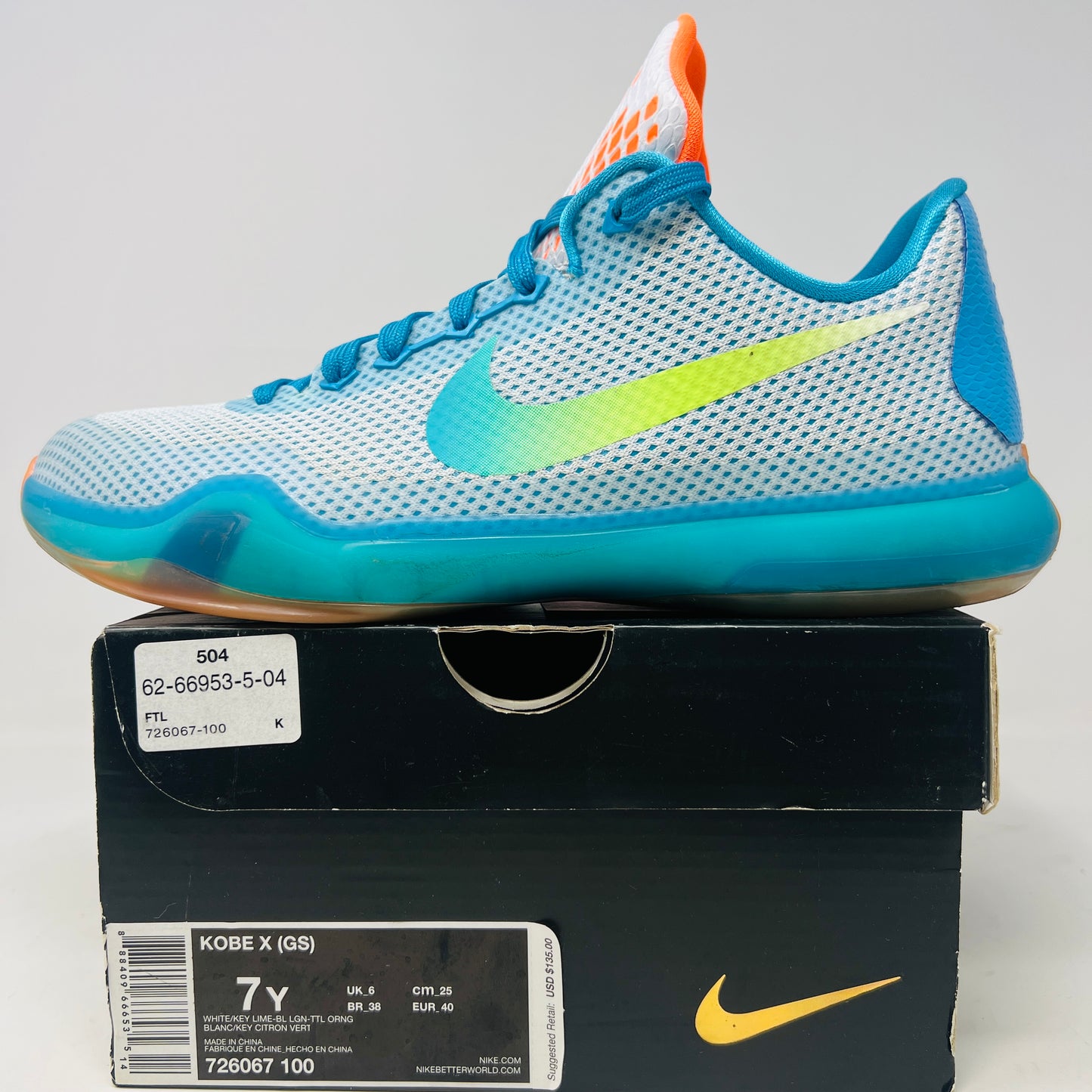 The Kobe 10 GS High Dive from Nike, in size 7Y, is on display with a blue upper, gradient yellow-green Swoosh, orange lining, and a multicolored sole. Its resting on its black box and shows normal wear.