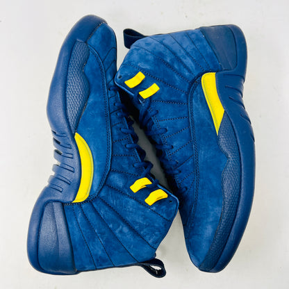 The Jordan 12 Retro Michigan is a blue high-top sneaker with yellow accents from Jordans 2018 Shoes collection. It features a textured surface, stitching details, and a visible Jumpman label. The dark blue sole highlights its vibrant design against a white background.