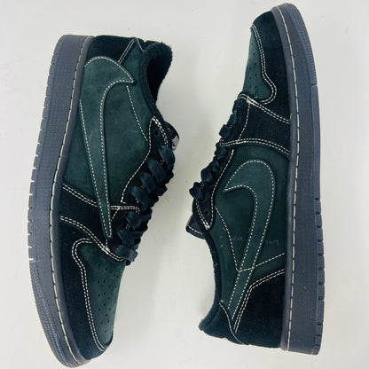 The Jordan 1 Retro Low OG SP Travis Scott Black Phantom is a stylish sneaker featuring a dark green suede upper with black leather accents, packed in a black shoebox. It comes with red and black-and-white patterned spare laces, showcasing its original swoosh design.