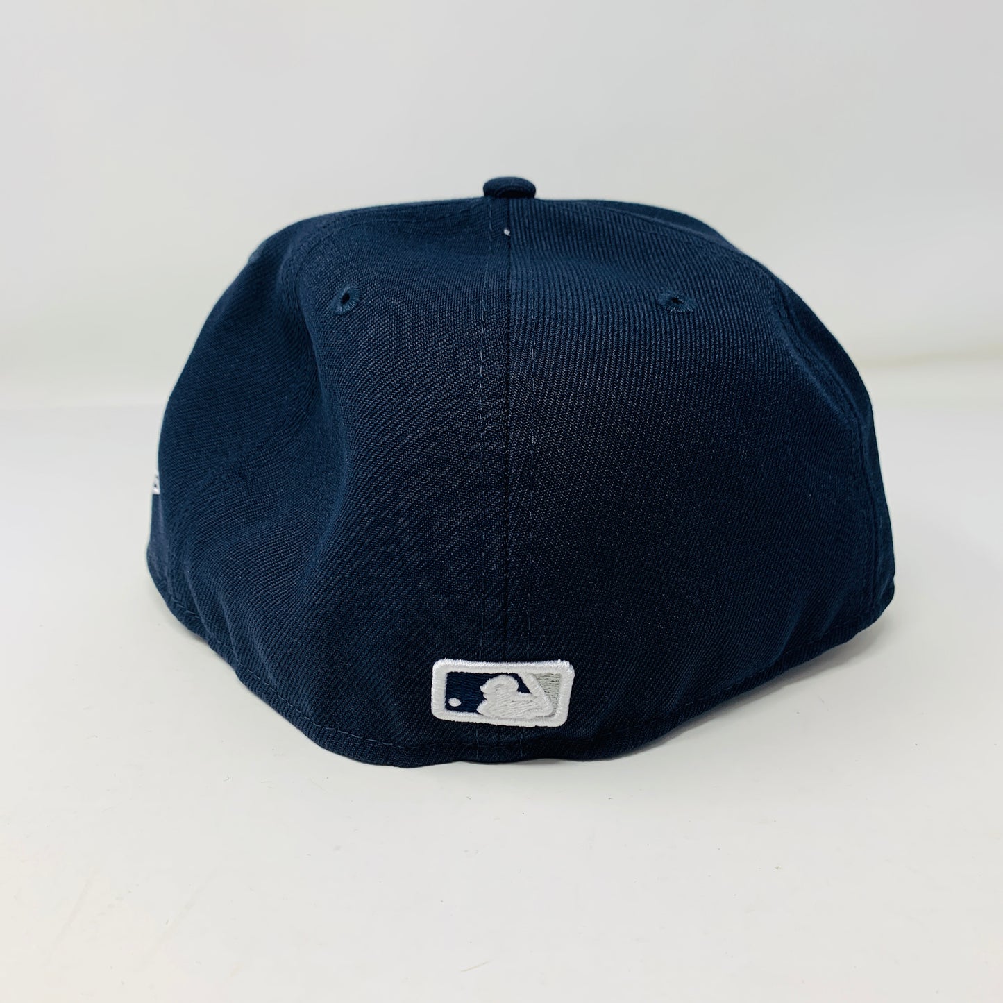 A navy Supreme MLB Teams New York Box Logo New Era 59Fifty fitted cap is shown with its back facing the viewer, displaying a small white MLB logo near the bottom against a plain white background.