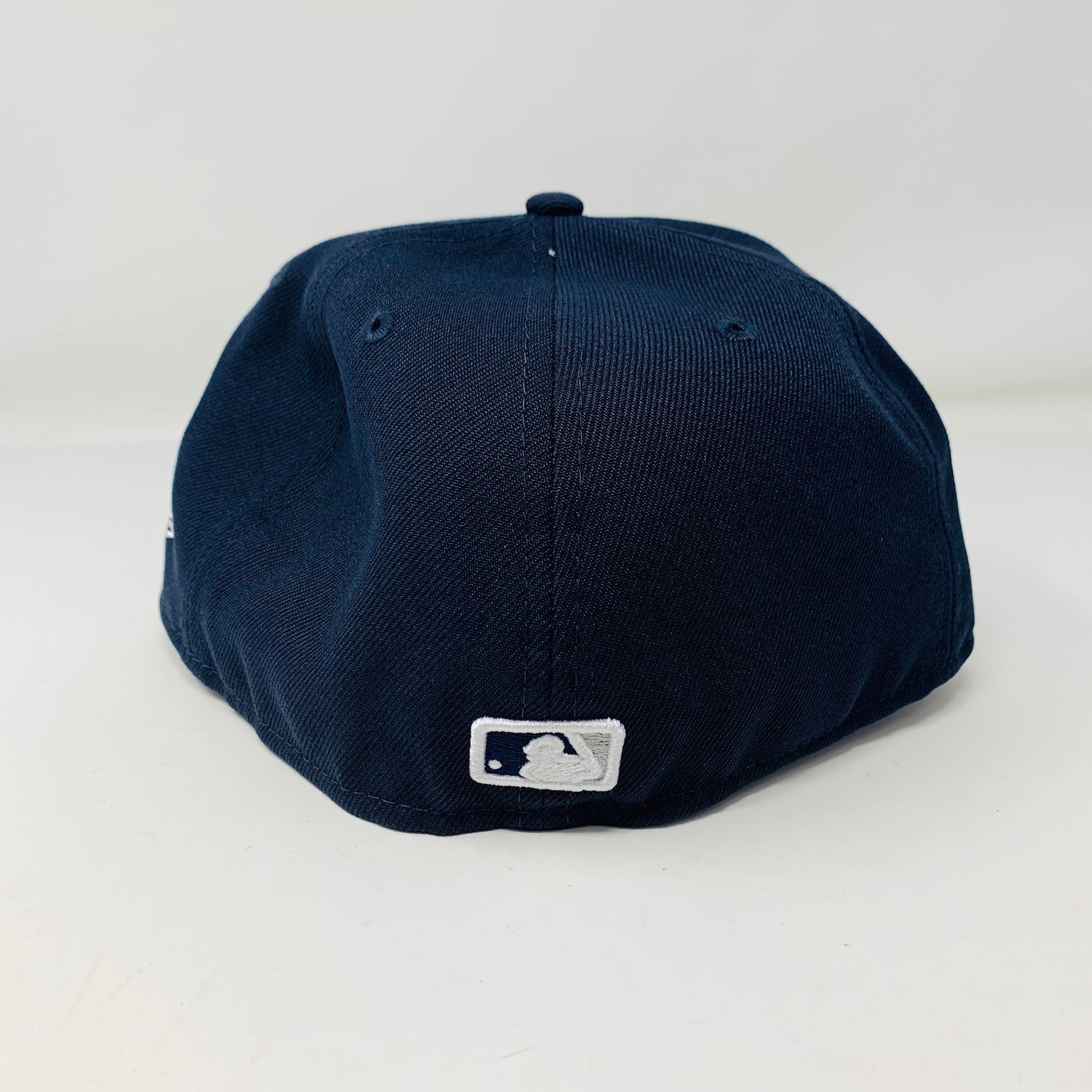 A navy Supreme MLB Teams New York Box Logo New Era 59Fifty fitted cap is shown with its back facing the viewer, displaying a small white MLB logo near the bottom against a plain white background.