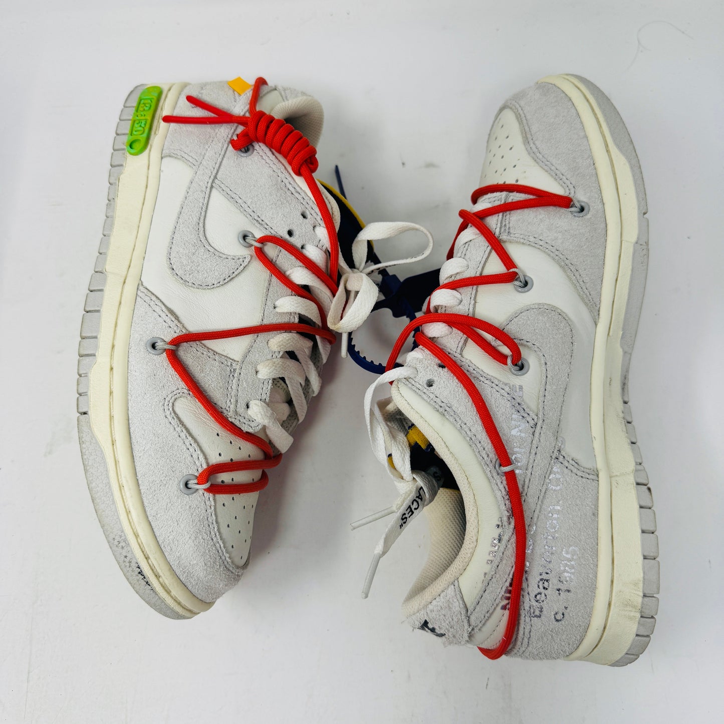 Nike Dunk Low Off-White Lot 13 sneakers with red laces and Off-White branding.