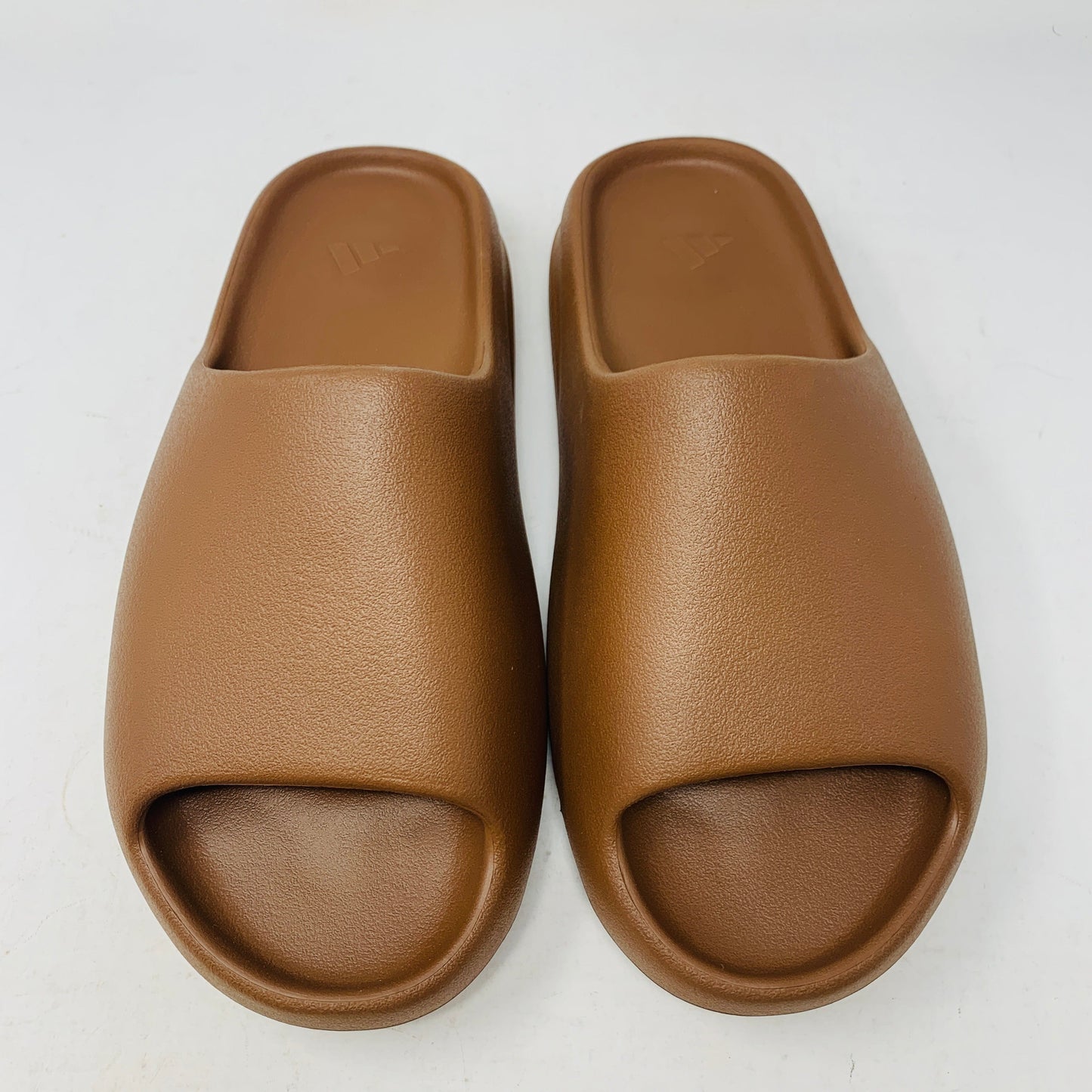 Yeezy Slide Flax in neutral colorway with iconic design by Kanye West.