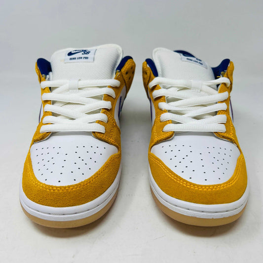 The 2020 Nike SB Dunk Low Laser Orange sneaker features a white base, yellow suede overlays, a dark blue swoosh, and white laces. It includes extra laces and is accented with a visible gum sole, all showcased against a plain white background to complete its authentic look.