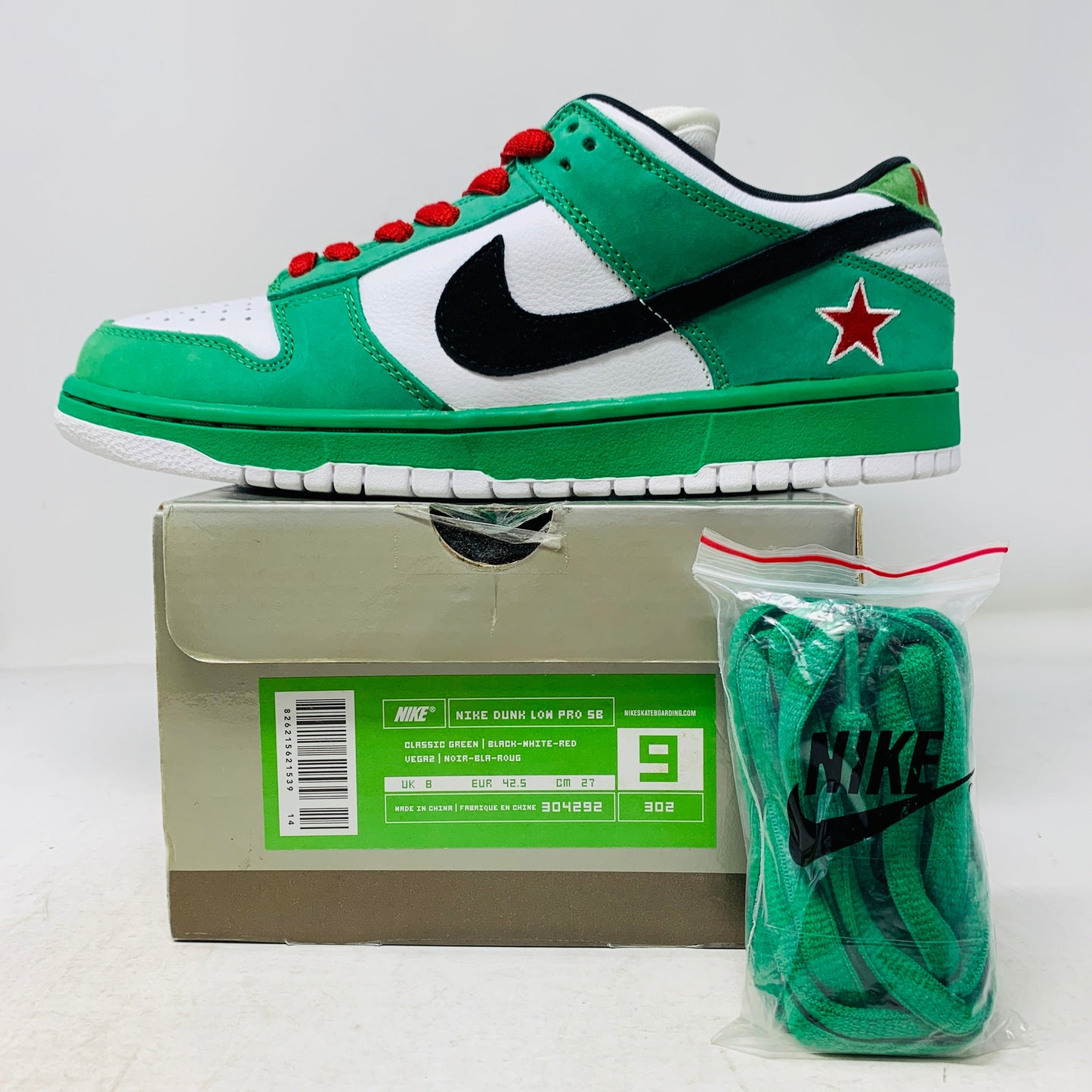 Nike SB Dunk Low Heineken sneaker, size 9M, with green laces and good box condition.