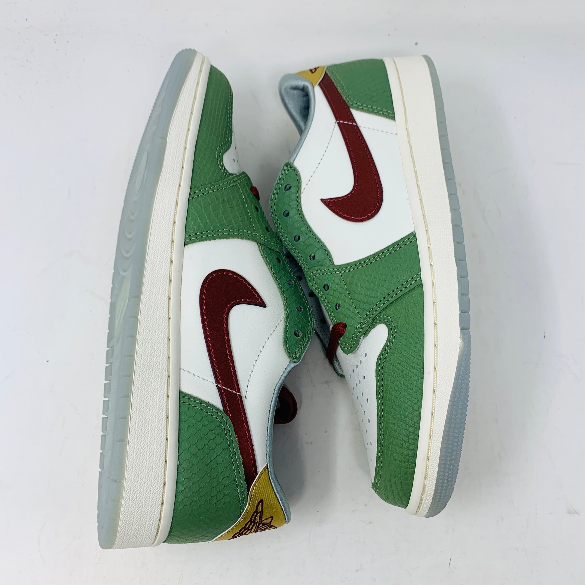 Jordan 1 Low Year Of The Dragon 2024 sneakers, green and white leather with red accents, brand new condition.