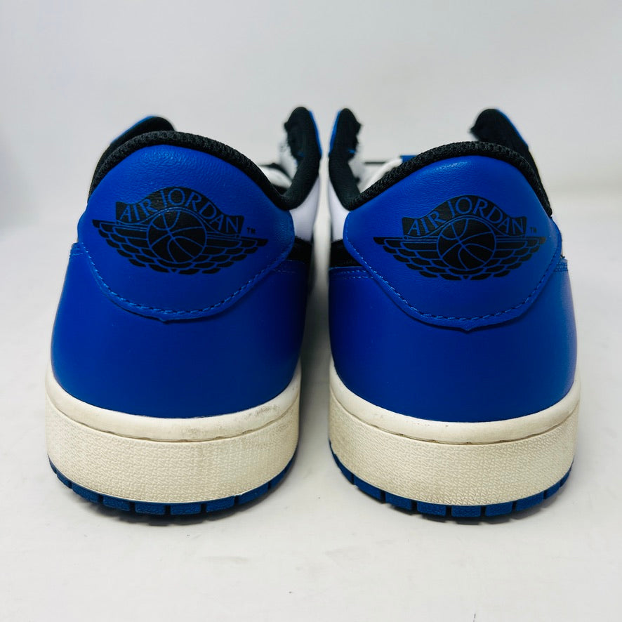 A Jordan 1 Retro Low OG Game Royal shoe in blue, white, and black is showcased on a matching blue Nike box. It features a black swoosh logo and the box label indicates size 12.