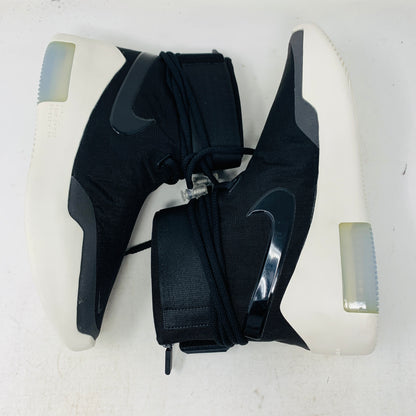 The Nike Air Fear Of God 1 SA Black, with its futuristic black high-top design, features a white sole, glossy black swoosh logo, distinctive lace loops, and an ankle velcro strap. This authentic sneaker sits atop an orange shoe box.