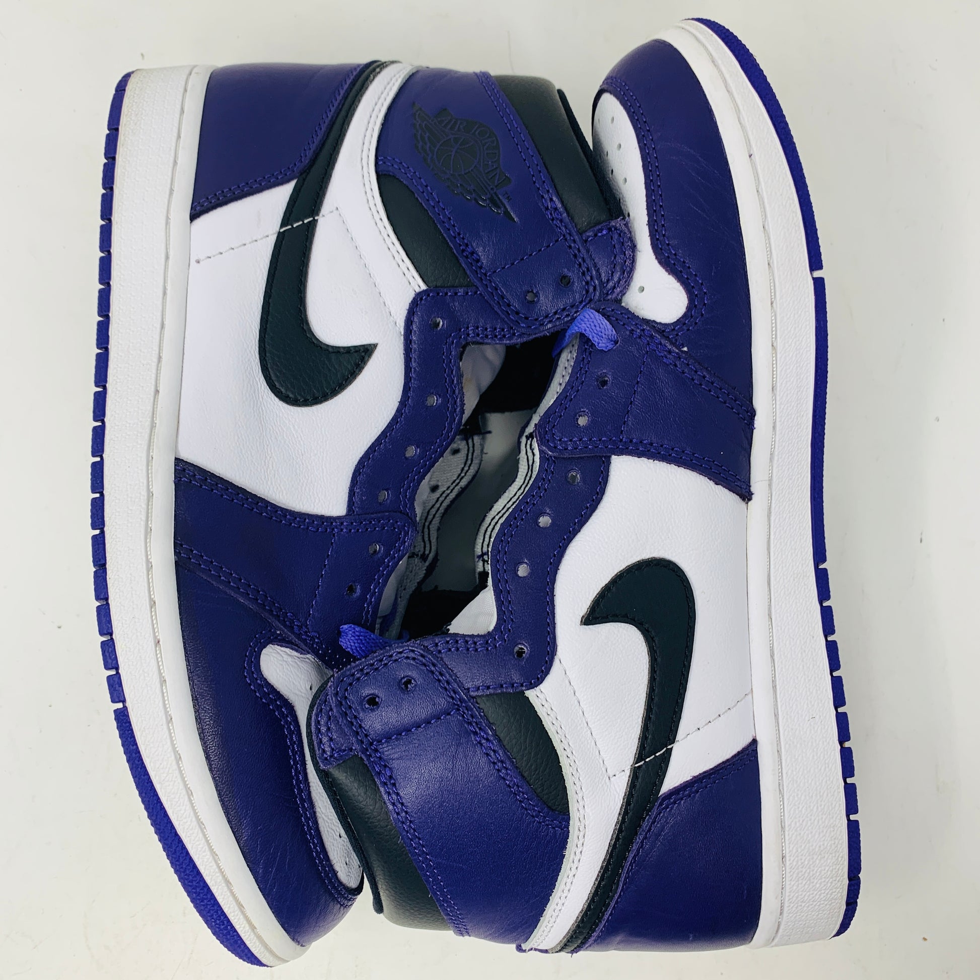 Jordan 1 Retro High Court Purple White sneakers size 9.5 on Nike box, purple and white uppers, black Swoosh, 2020 edition.