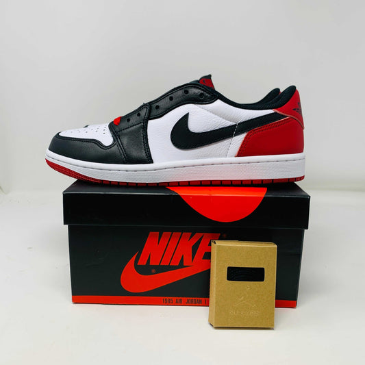 Jordan 1 Retro Low OG Black Toe 2023 sneaker in black, white, and red, displayed on Nike box.