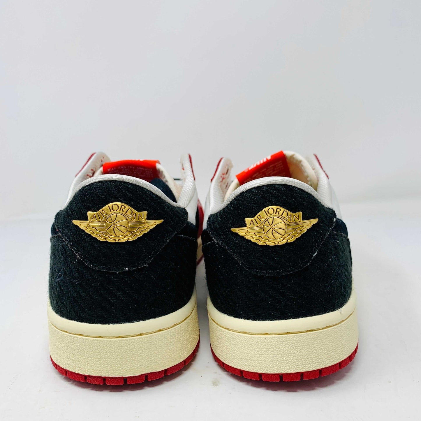 Jordan 1 Retro Low OG Trophy Room Away black and gold sneakers with Trophy Room logo.