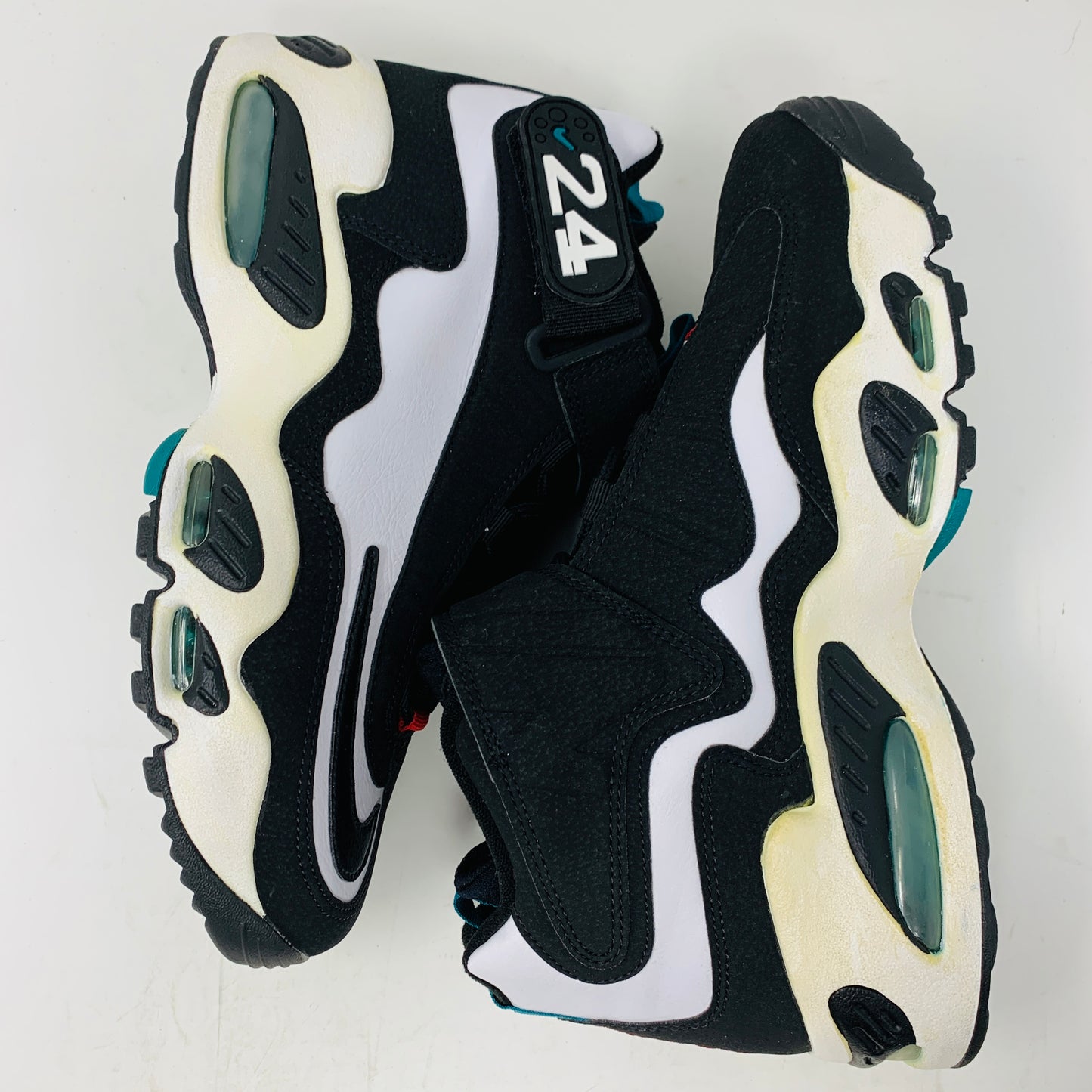 The Nike Air Griffey Max 1 White Freshwater (2016) features a black and white design with 24 on the strap, bold white and teal accents, wavy side designs, air cushioning in the sole, and a yellowed midsole for vintage charm.