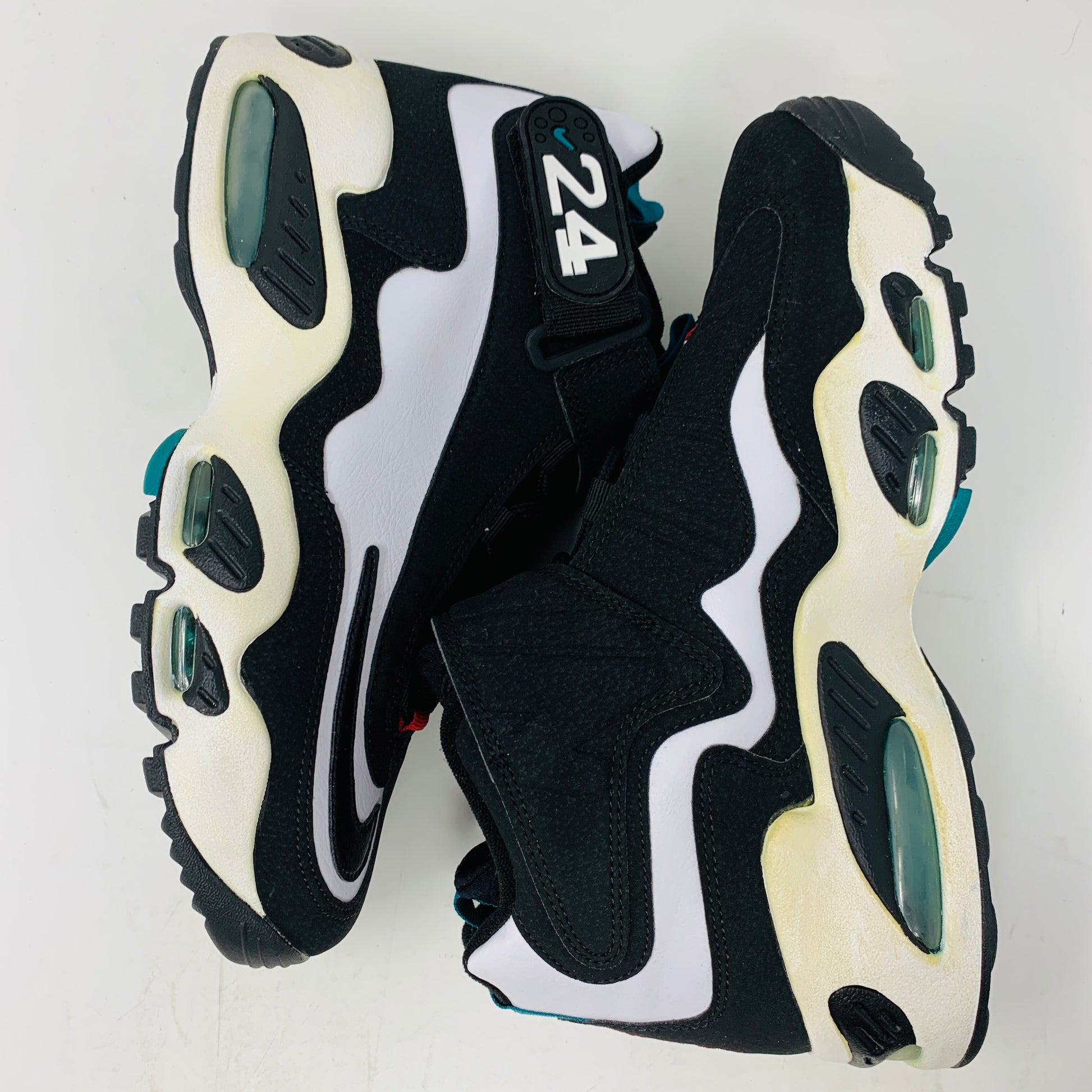 The Nike Air Griffey Max 1 White Freshwater (2016) features a black and white design with 24 on the strap, bold white and teal accents, wavy side designs, air cushioning in the sole, and a yellowed midsole for vintage charm.